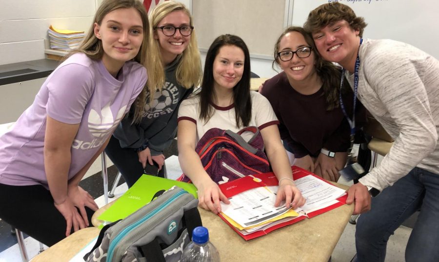 Alyssa Twigg, Maddie Davis, Erika Frye, Madi Domico, and Parker Marshall huddle together to discuss Prom.