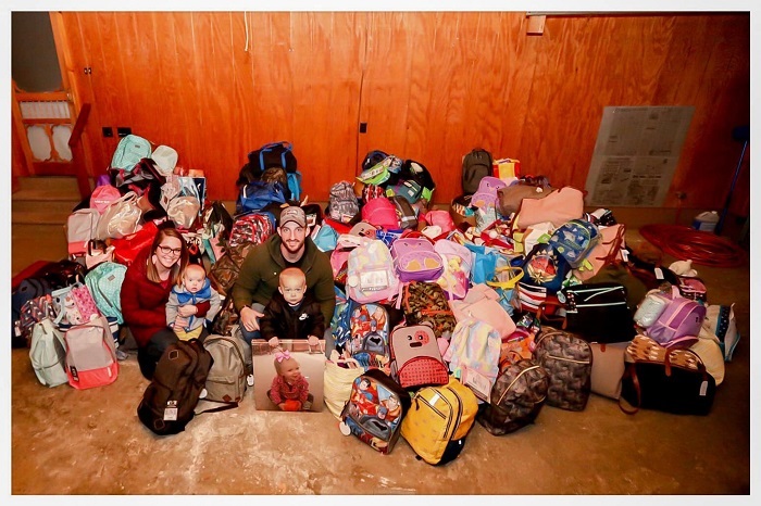 A photo of the family of Kinsley with the foster care bags everyone put together. 