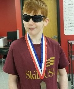 Cameron with his second place medal at the Skills USA competition. 