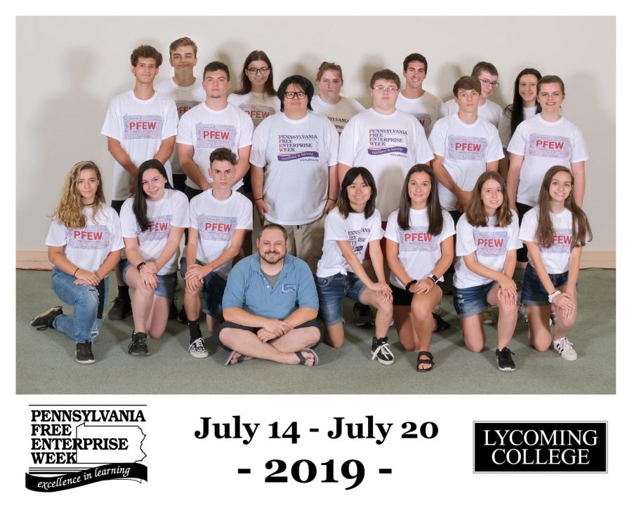 Rachel Owens, kneeling, lower left, poses with her group at PFEW. 