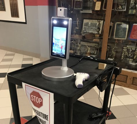Temperature scanner in lobby of high school.