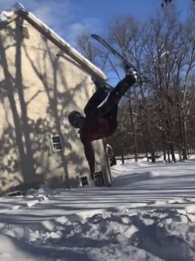 Justin Hand goes flying during a snow day with Haden Allison.