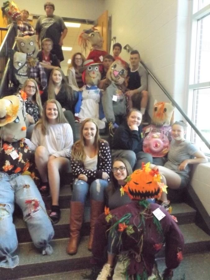 Some of the students who constructed scarecrows for the annual downtown Fall Fest and Pumpkin Run.