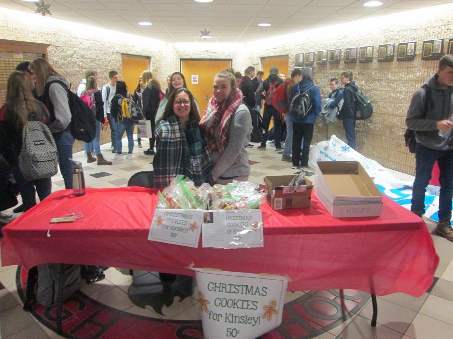 Two helpers selling treats during the bake sale.
