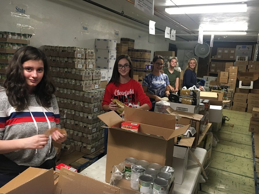 Jamie Irwin, Reagen Rupp, Kelcie Van Tassel, Brianna Miller and Nevaeh Moore help bag foods at the food bank.