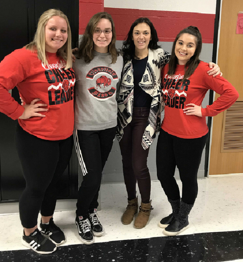 From left to right, Brianna Shaw, Makeeli Redden, Mrs. Zimmerman, and Ally Hertlein standing in the hall smiling.