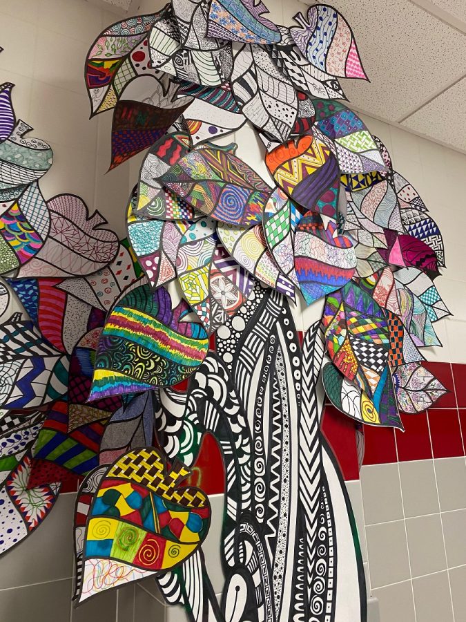 The art department has created a zentangle tree displayed in the art hallway.