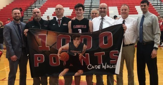 Cade Walker, center, and coaches celebrate Cades 1,000-point record.