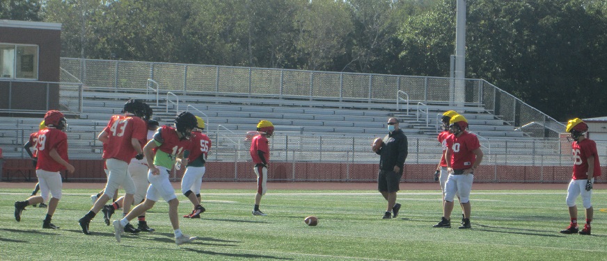 The football team practices for the next game.