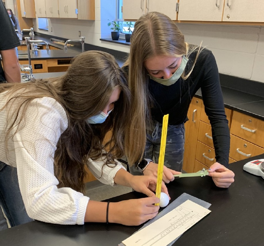 Abby Ryan and Mckenna Lanager work on a physics project.